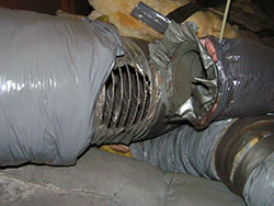 Dirty air ducts blowing air in the attic. Heating and air conditioning ducts.